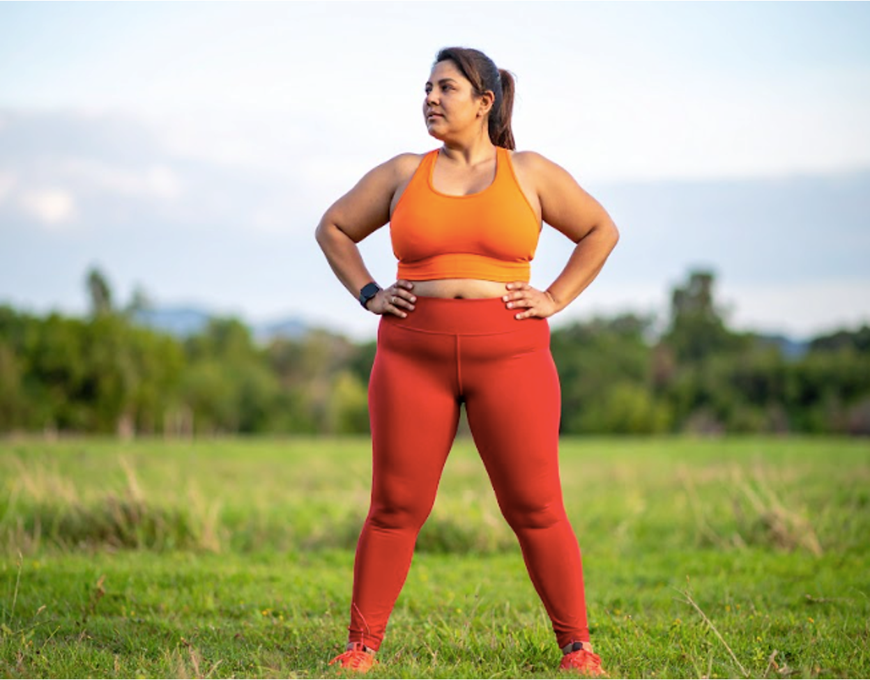 A person wearing workout clothes standing in a field