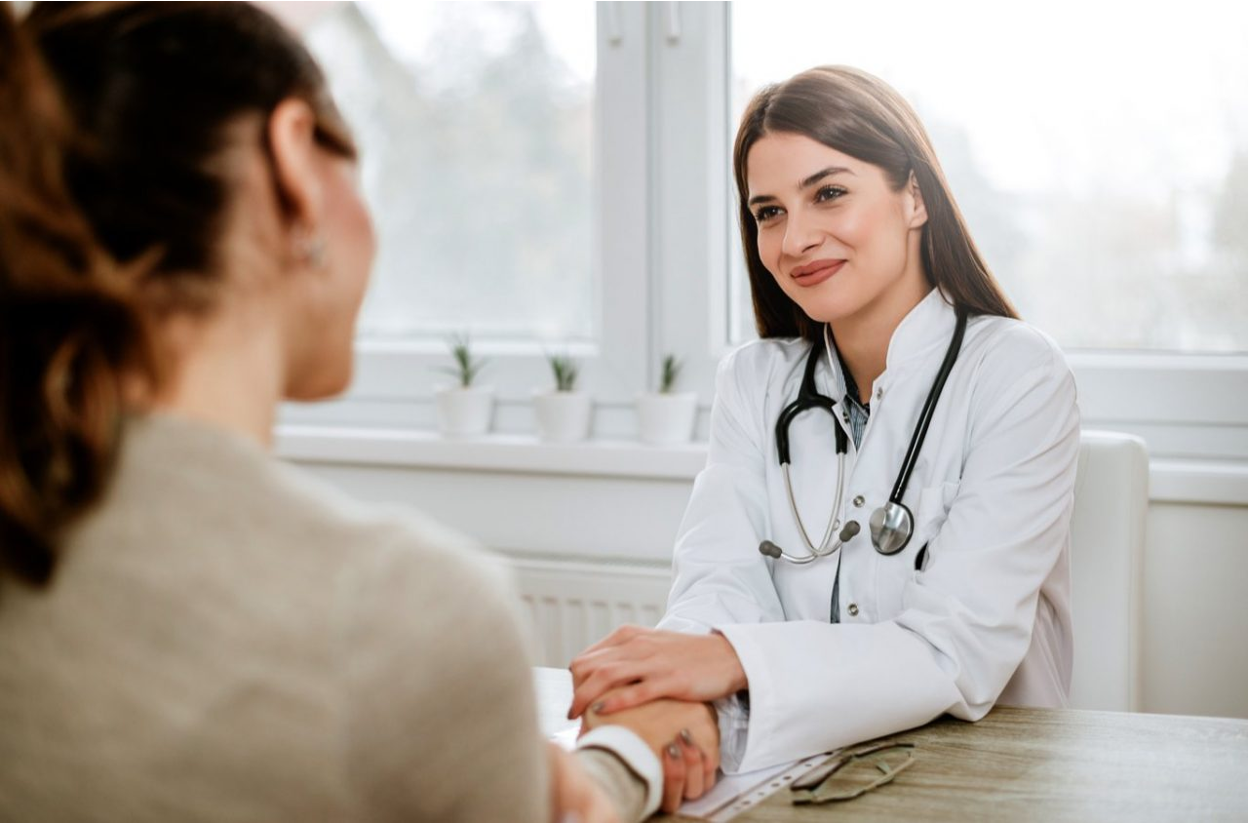 Doctor reassuring a patient during a consultation about long-term GLP-1 medication side effects in a bright clinic setting