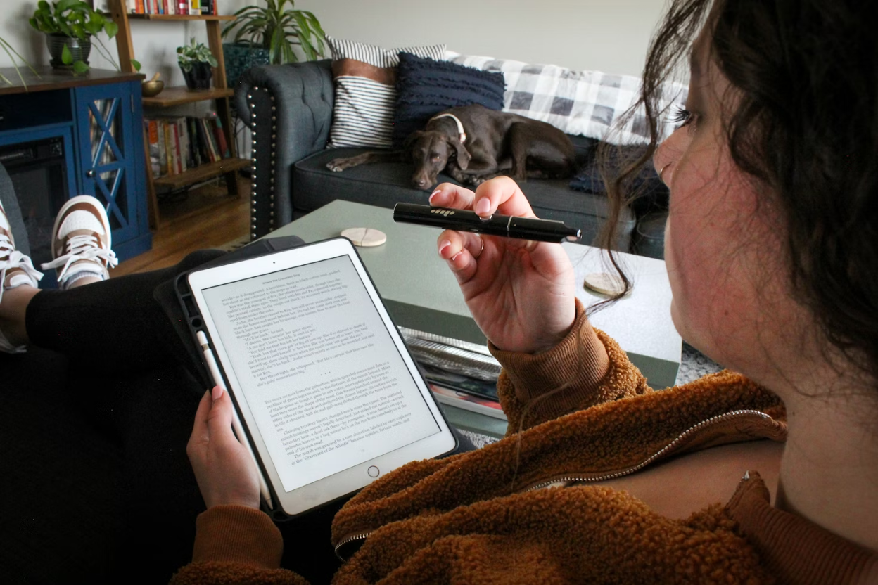 Woman sitting in a chair using a tablet in the comfort of her home