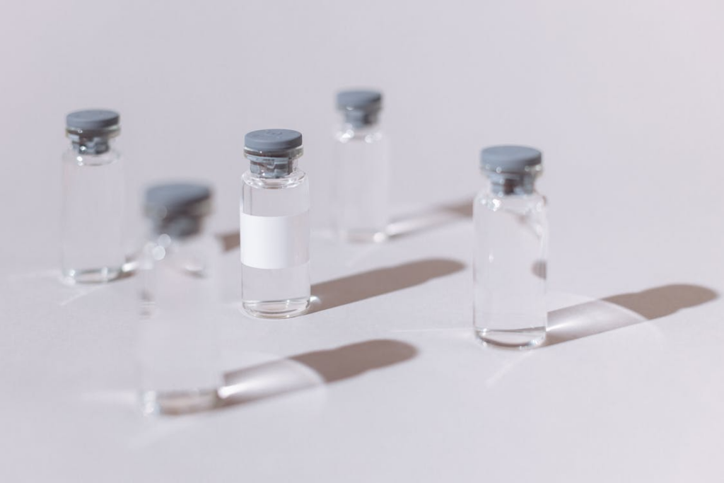 Glass medicine vials on a white surface 