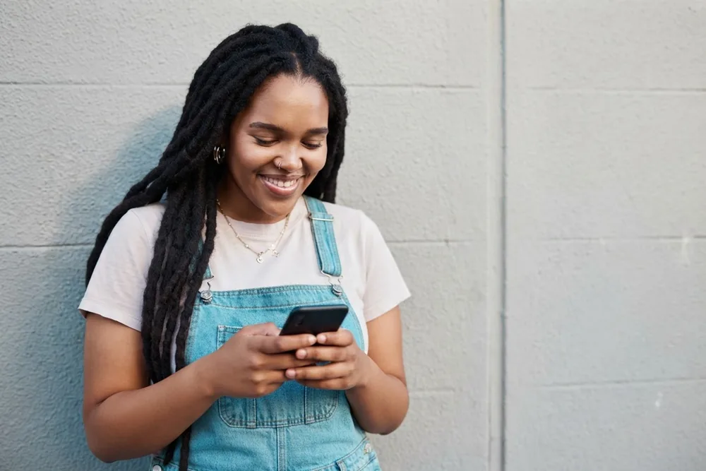 Woman smiling at her phone