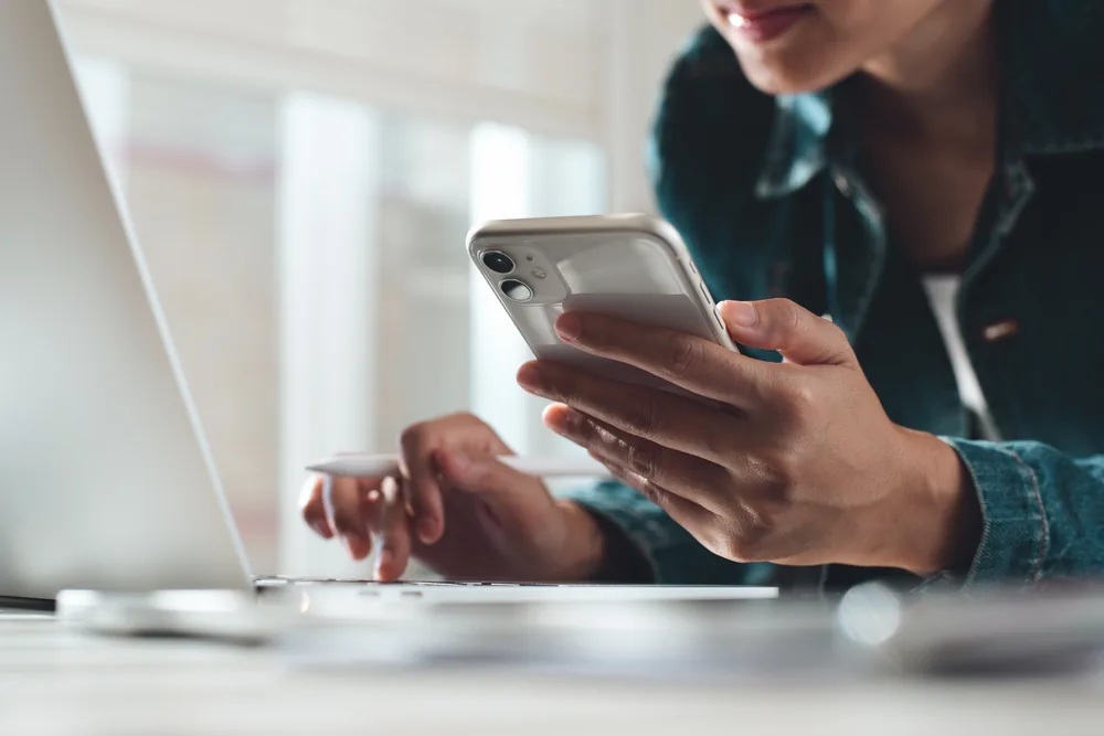 Person using a phone at a desk